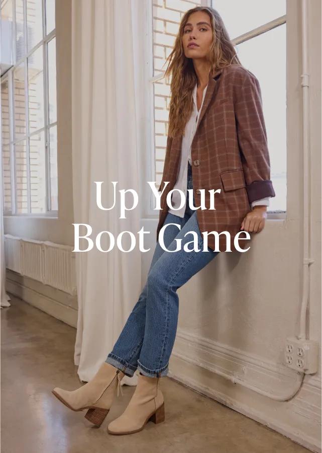 Up Your Boot Game. Shop Now. Model wearing Evelyn Heeled Boot in Natural Suede Deco Stitch.